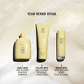 A bottle of shampoo, a tube of conditioner, and a pump bottle of Oribe Hair Alchemy Bond Repair Leave-In Treatment arranged as a three-step hair bond repair ritual.