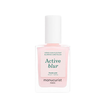 A bottle of powder-pink Manucurist Active Blur care polish with a white cap and a label reading Active blur.