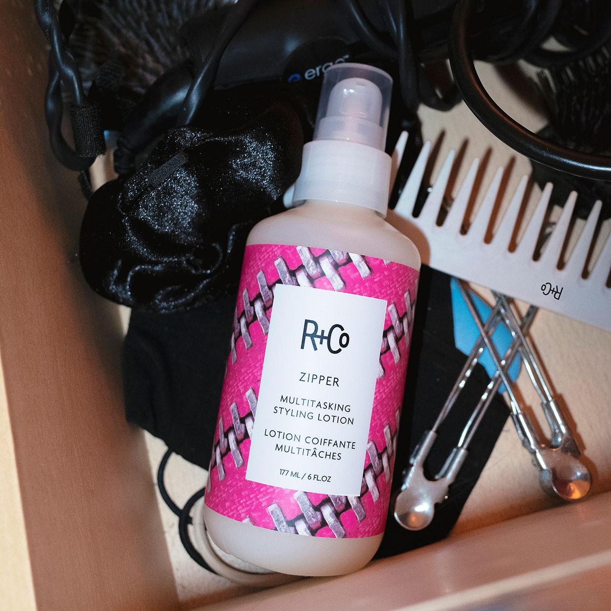 Lifestyle image of R+Co Zipper Multitasking Styling Lotion