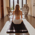 Lifestyle image of HigherDose Infrared PEMF Mat