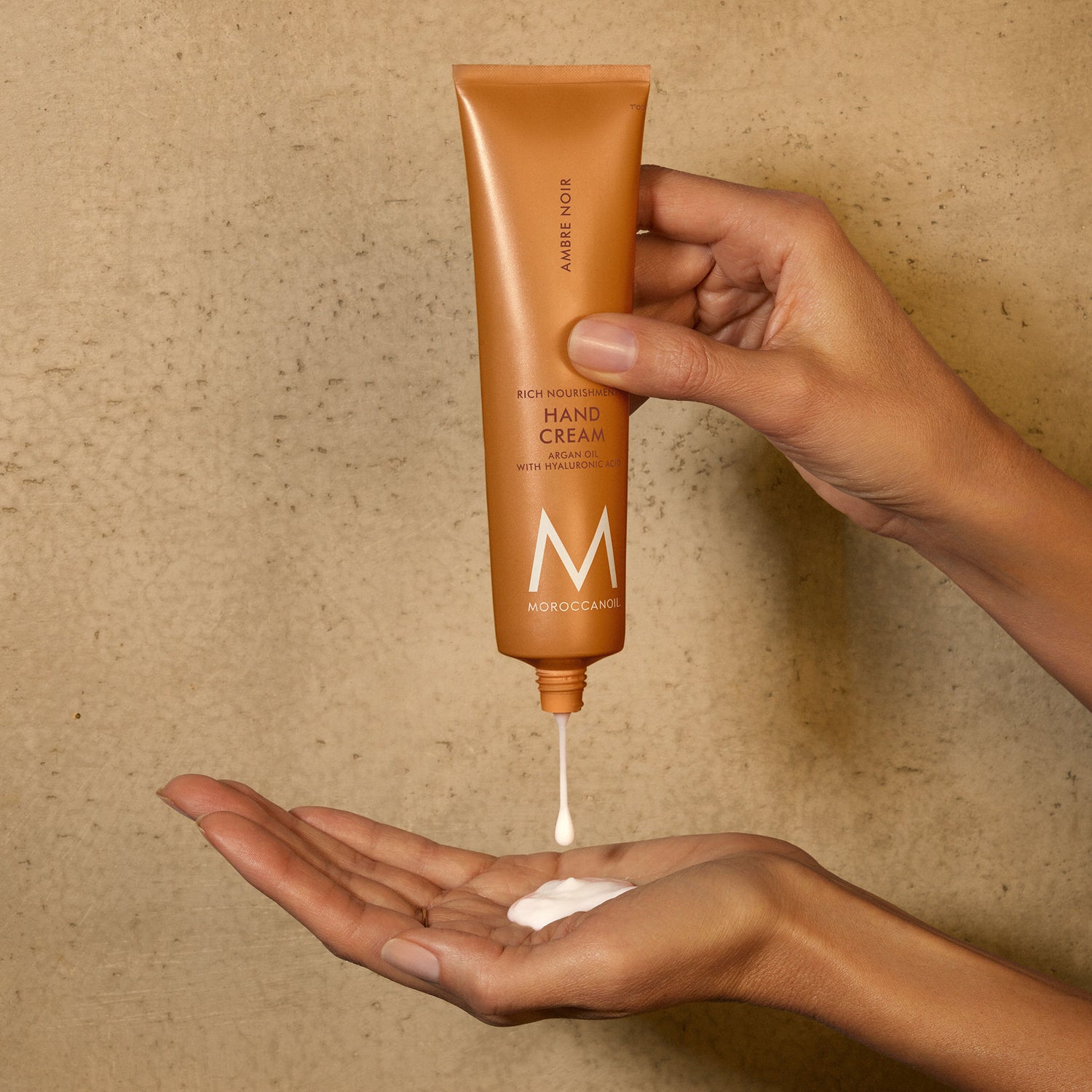 Lifestyle image of Moroccanoil Hand Cream Ambre Noir variant: 3.4 fl oz