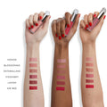 An arm swatch of Kjaer Weis Matte, Naturally Liquid Lipstick variant: KW Red