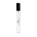A cylindrical Liberty LBTY. Adelphi Sun Eau De Parfum rollerball with a black cap, featuring the text ADELPHI SUN and a logo printed on the side, displayed against a sunlit glasshouse backdrop.