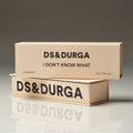 Two cream-colored transparent D.S. & Durga I Don’t Know What Eau de Parfum boxes stacked on a reflective surface, with the brand and product names printed in black text.