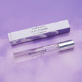 A glass rollerball of 11 11 Lychee Eau de Parfum and its matching rectangular box.