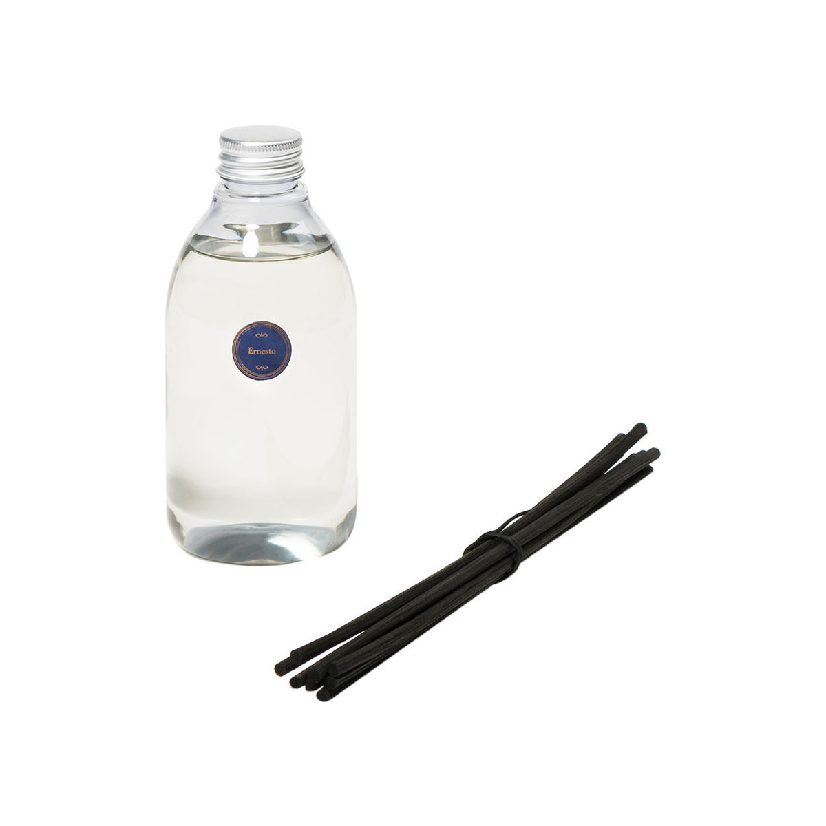 Ernesto Diffuser glass bottle of leather and tobacco fragrance oil with a silver cap and a round blue label, accompanied by a bundle of black diffuser reeds.