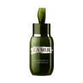 Dark green glass bottle of La Mer The Concentrate reparative barrier serum with a dropper cap.