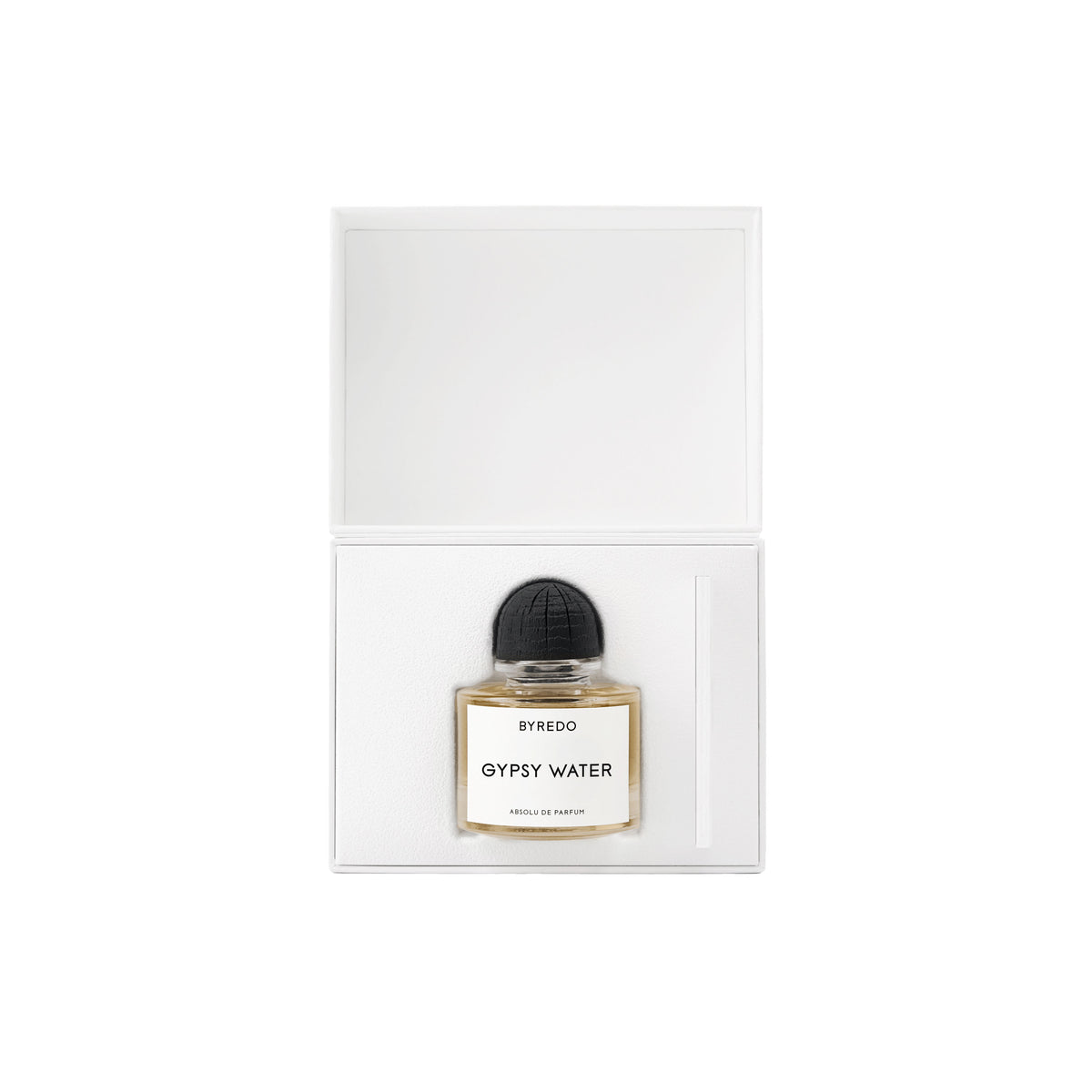 A glass Gypsy Water Absolu de Parfum bottle with a black cap, resting inside an open white box.
