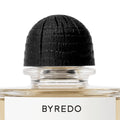 A glass bottle of Gypsy Water Absolu de Parfum with a textured black cap and a white label featuring the Byredo brand name in black text.