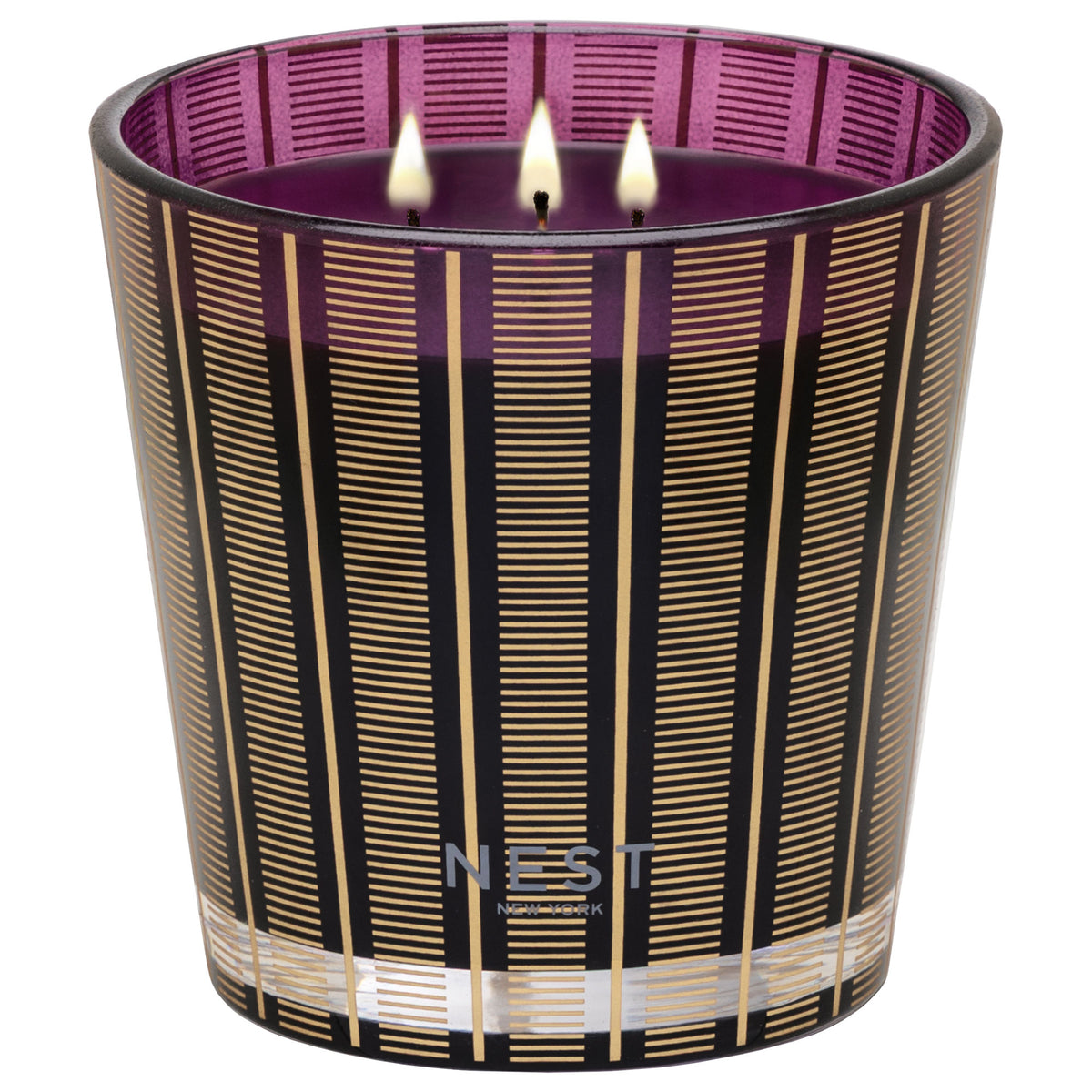 A three-wick Nest New York Autumn Plum Candle in a deep purple glass vessel decorated with vertical black and gold stripes.