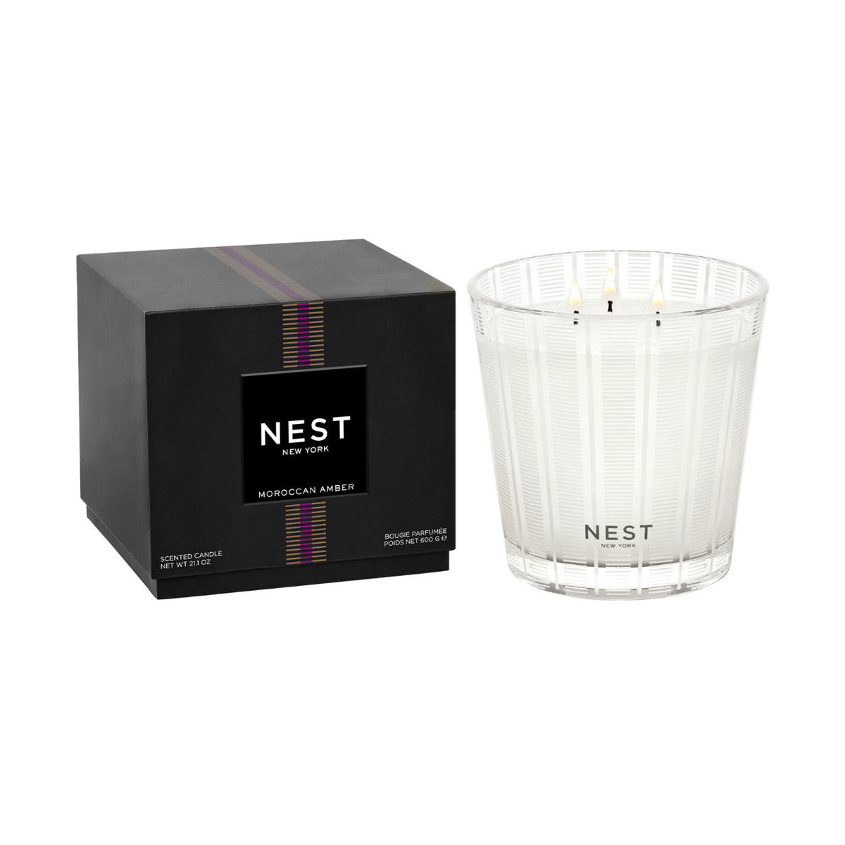 A black square box next to a Moroccan Amber Candle in a clear textured glass vessel.