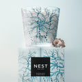 Lifestyle image of Nest Ocean Mist & Sea Salt Decorative Luxury Candle variant: 21.2 oz (3-Wick)