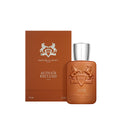 A brown rectangular Althaïr Exclusif Parfum bottle with a silver cap and a horse crest, next to its matching brown box featuring notes of saffron and Bourbon vanilla.