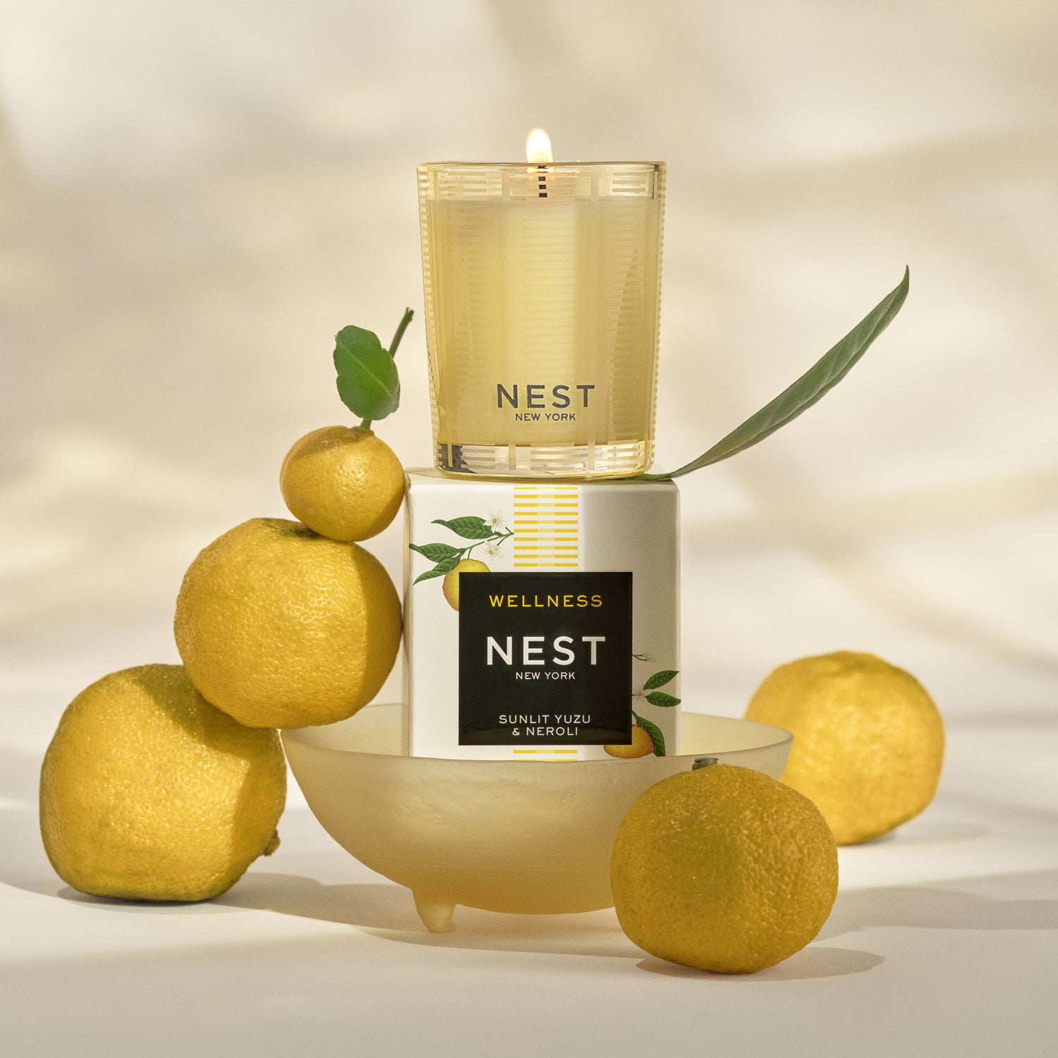 Lifestyle image of Nest Sunlit Yuzu & Neroli Candle variant: 2 oz (Votive)