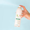 Lifestyle image of Klorane Dry Shampoo With Oat Milk for Dark Hair variant: 3.2 oz