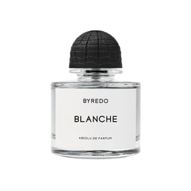 A clear glass Byredo Blanche Absolu Parfum bottle with a white label under a round, textured black cap, evoking the scent of fresh linen.