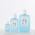Three bottles of Ellis Brooklyn Salt Eau de Parfum in varying sizes, each with a white cap and a label evoking salty skin and tropical florals.