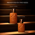 Two amber-colored Althaïr Exclusif Parfum bottles of 125 ml and 75 ml, featuring notes of saffron and Bourbon vanilla, resting on steps.