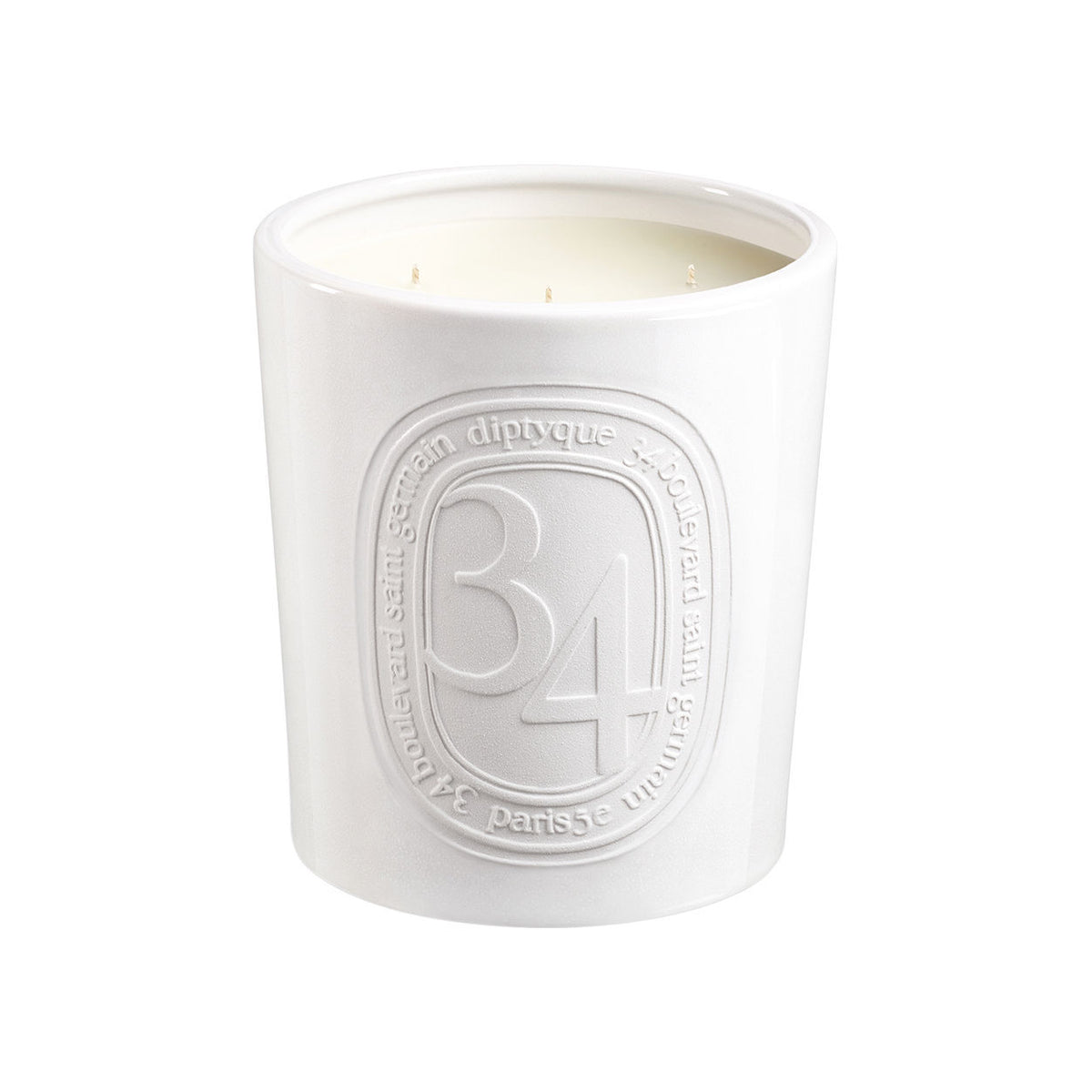 White 34 Boulevard Saint Germain Candle in a ceramic vessel featuring an embossed oval logo with the text 34 boulevard saint germain.