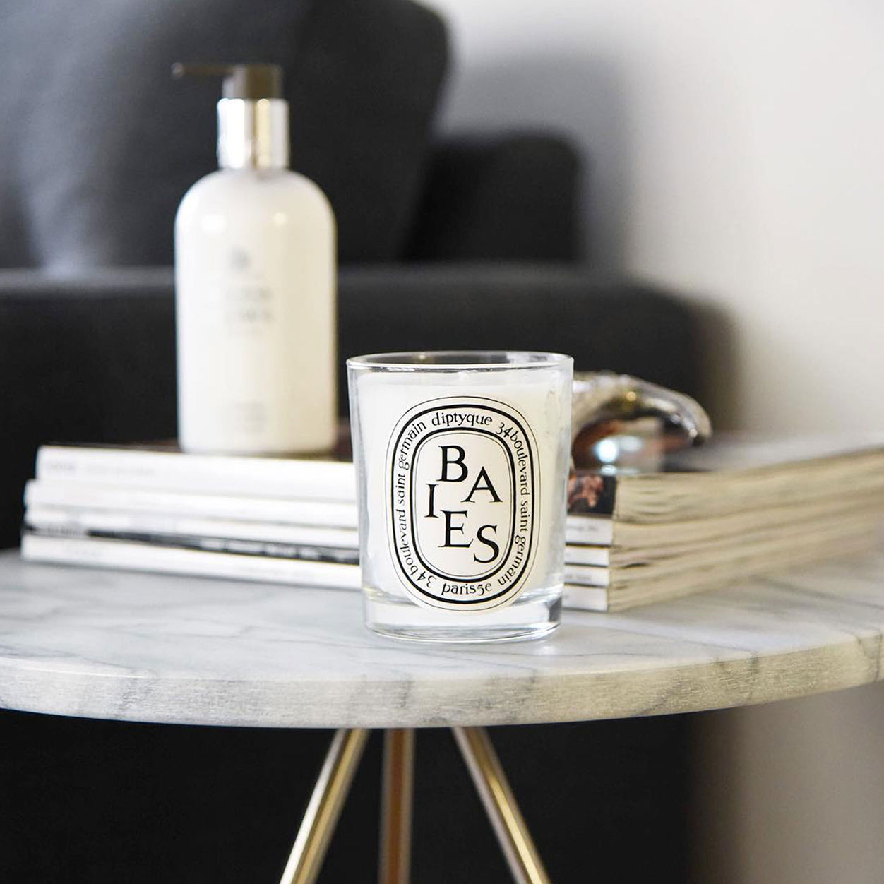 Lifestyle image of Diptyque Baies (Berries) Candle variant: 6.7 oz (Classic)