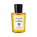A glass bottle of Buongiorno Eau de Parfum with a black cap and a white label featuring a crest and text, holding an amber-colored liquid that evokes spring in Tuscany.