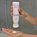 Lifestyle image of Virtue Smooth Shampoo variant: 8 oz