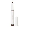 Brown Jane Iredale ColorLuxe Eye Shadow Stick in a white twist-up casing with its matching cap removed and standing beside it.