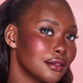 Model image of Charlotte Tilbury Unreal Lip + Cheek Glow Blush Stick with Hyaluronic Acid variant: Berry Glow