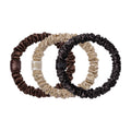 Three Pure Silk Skinny Scrunchie Trio Ornament anti-breakage skinny hair scrunchies in shades of dark brown, tan, and black, each featuring a small woven logo tag.