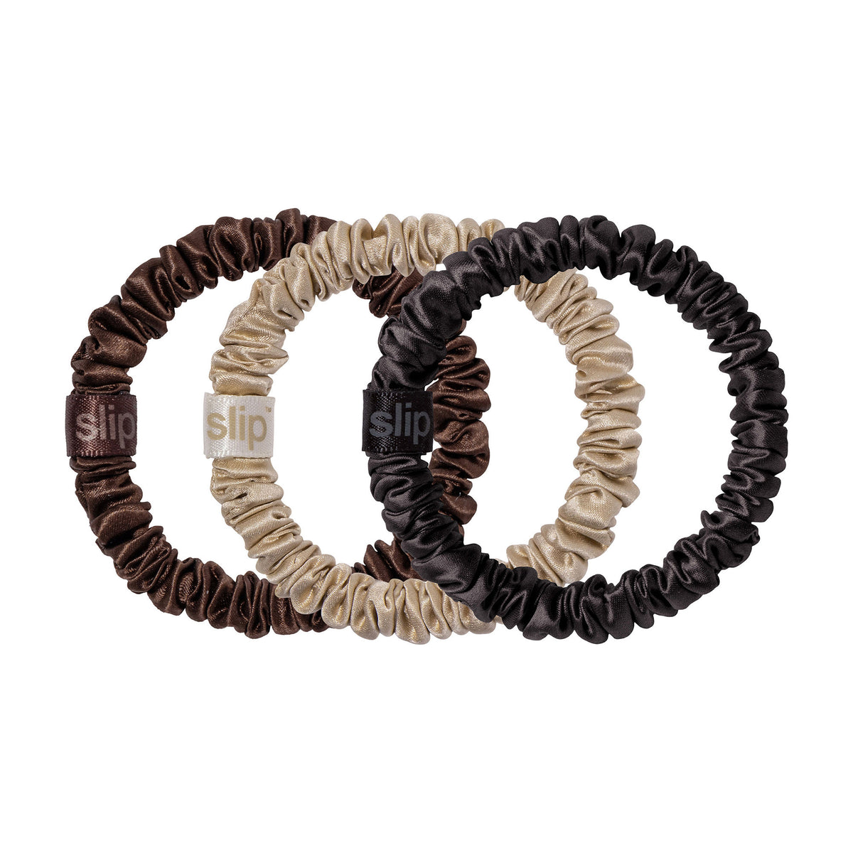 Three Pure Silk Skinny Scrunchie Trio Ornament anti-breakage skinny hair scrunchies in shades of dark brown, tan, and black, each featuring a small woven logo tag.