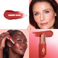 Model image of Charlotte Tilbury Unreal Lip + Cheek Glow Blush Stick with Hyaluronic Acid variant: Cherry Glow