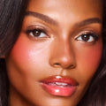 Model image of Charlotte Tilbury Unreal Lip + Cheek Glow Blush Stick with Hyaluronic Acid variant: Cherry Glow