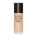 A bottle of Bobbi Brown Weightless Skin Foundation SPF 15 with a black cap, featuring brand text and product details printed on the front, designed to minimize pores and control oil.