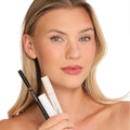 A woman with naturally fuller, glossy nude lips holds the Trish McEvoy The Bluemercury Exclusive Plump, Protect & Perfect Nude Lip Wardrobe (Limited Edition) lip liner and two tubes of lip products to achieve lip perfection.