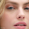 Close-up of a person wearing soft pink Cashmere Matte Eyelights and matching lipstick, with the text Desert Rose in the bottom left corner.