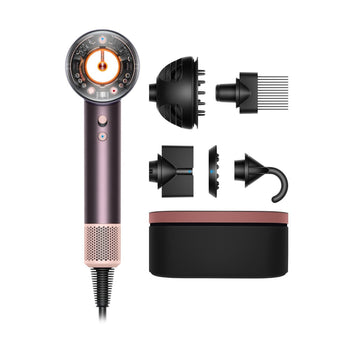 A Dyson Supersonic Nural hair dryer with a transparent head and its four distinct styling attachments for intelligent drying, arranged next to a storage case.