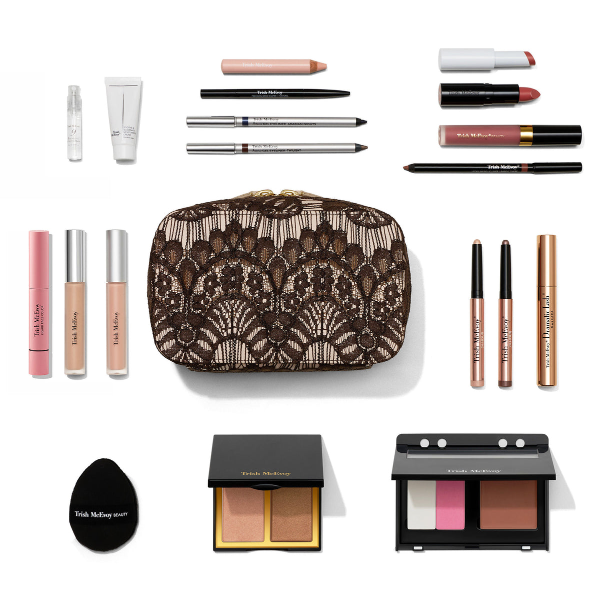 The Trish McEvoy The Bluemercury Exclusive Holiday Makeup Wardrobe (Limited Edition) features a lace-patterned cosmetics bag surrounded by face makeup, lip colors, eyeliner, eyeshadow sticks, mascara, a sponge, and two compact palettes.