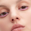 Close-up of eyes wearing matte pink EyeWear by Victoria Beckham Beauty on the lower lash line.