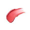 A thick, curved smear of Lune+Aster Cream Multi-Stick in a coral pink shade.