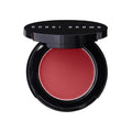 Open mirrored compact of Bobbi Brown Pot Rouge For Lips and Cheeks containing a circular pan of deep red cream.