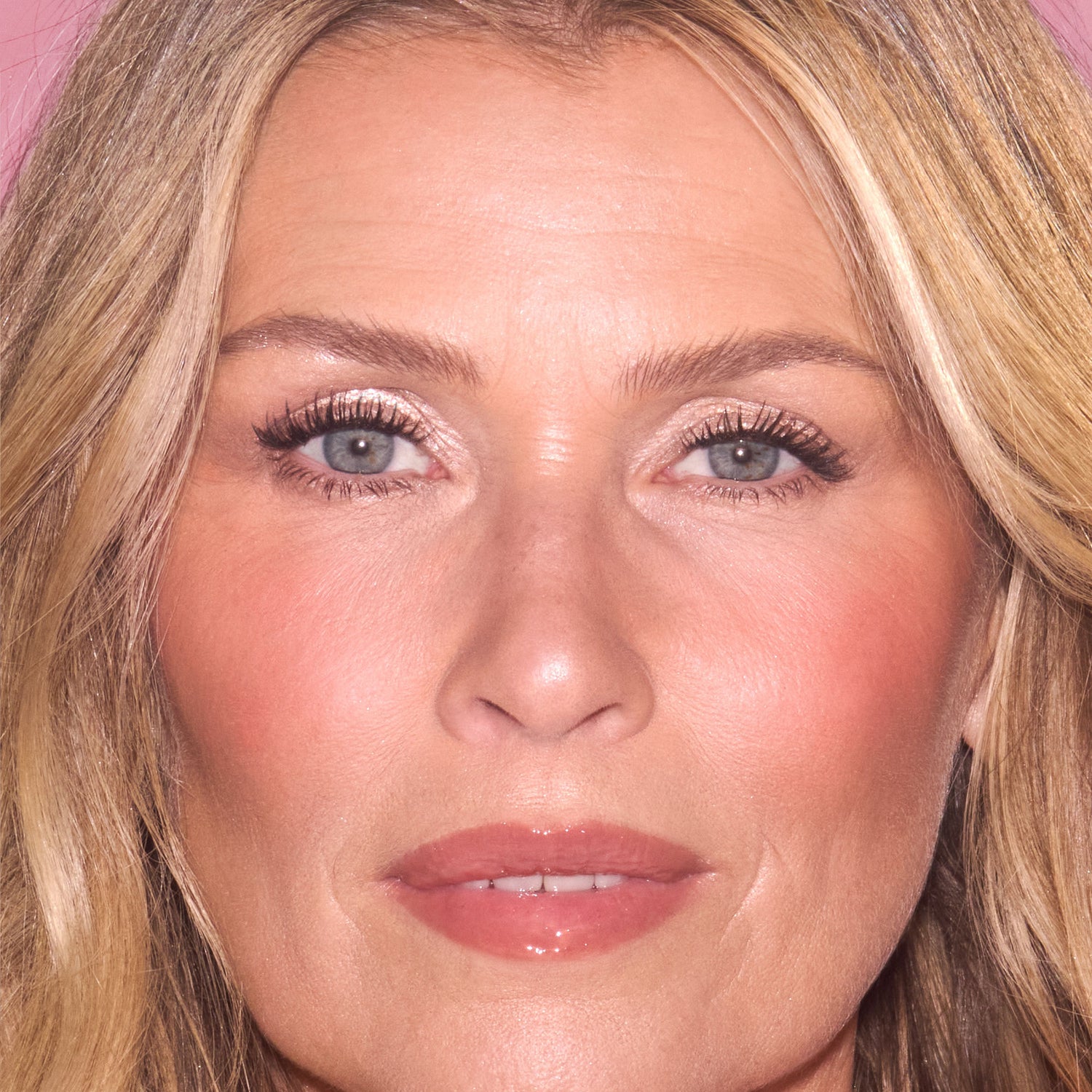 Model image of Charlotte Tilbury Unreal Lip + Cheek Glow Blush Stick with Hyaluronic Acid variant: Rosy Glow