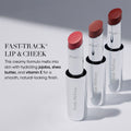 Three Trish McEvoy Fast-Track Lip & Cheek tubes in light pink, rose, and deep red standing upright, each offering buildable color with an effortless swipe.
