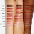 An arm swatch of Nars Afterglow Lip Shine variant: Triple X